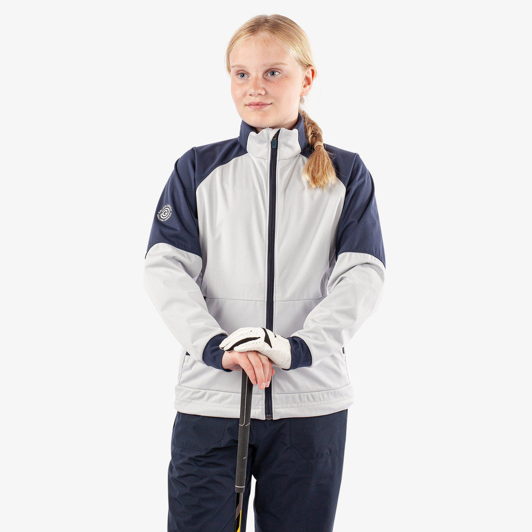 Remi is a Windproof and water repellent golf jacket for Juniors in the color Cool Grey/Navy/White(2)