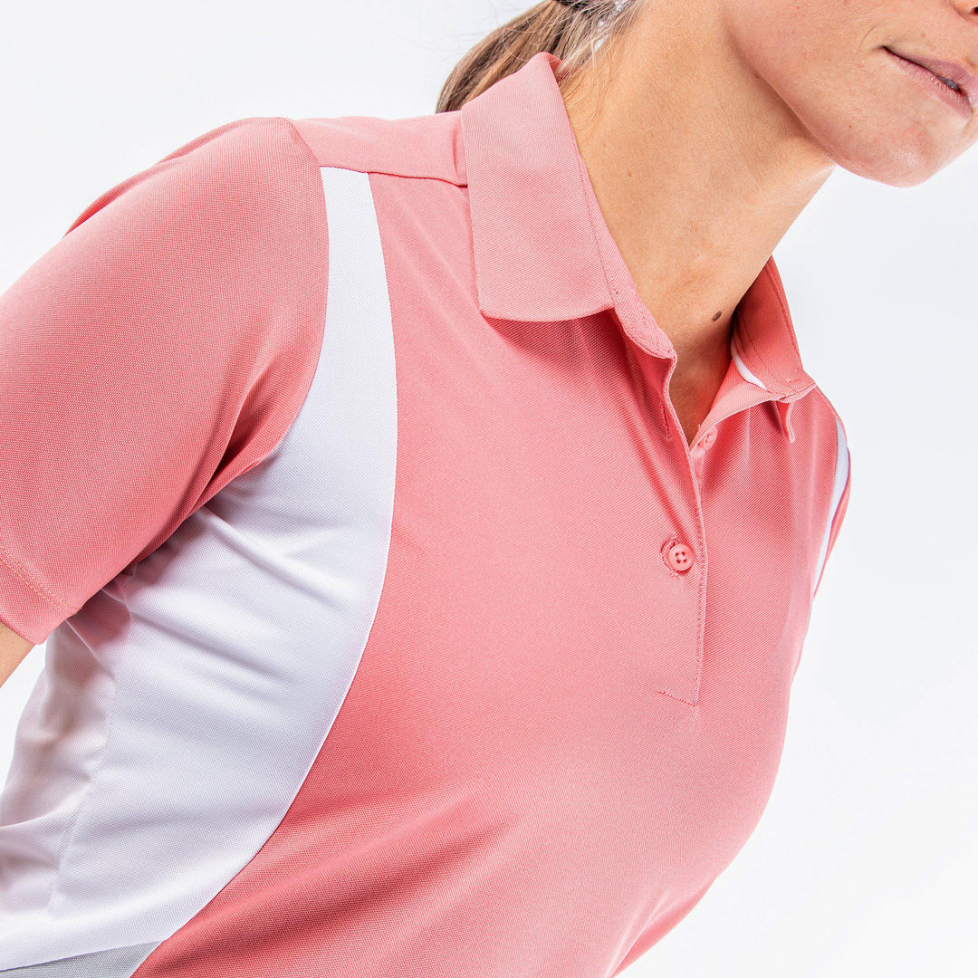 Melanie is a Breathable short sleeve golf shirt for Women in the color Coral/White/Cool Grey(2)