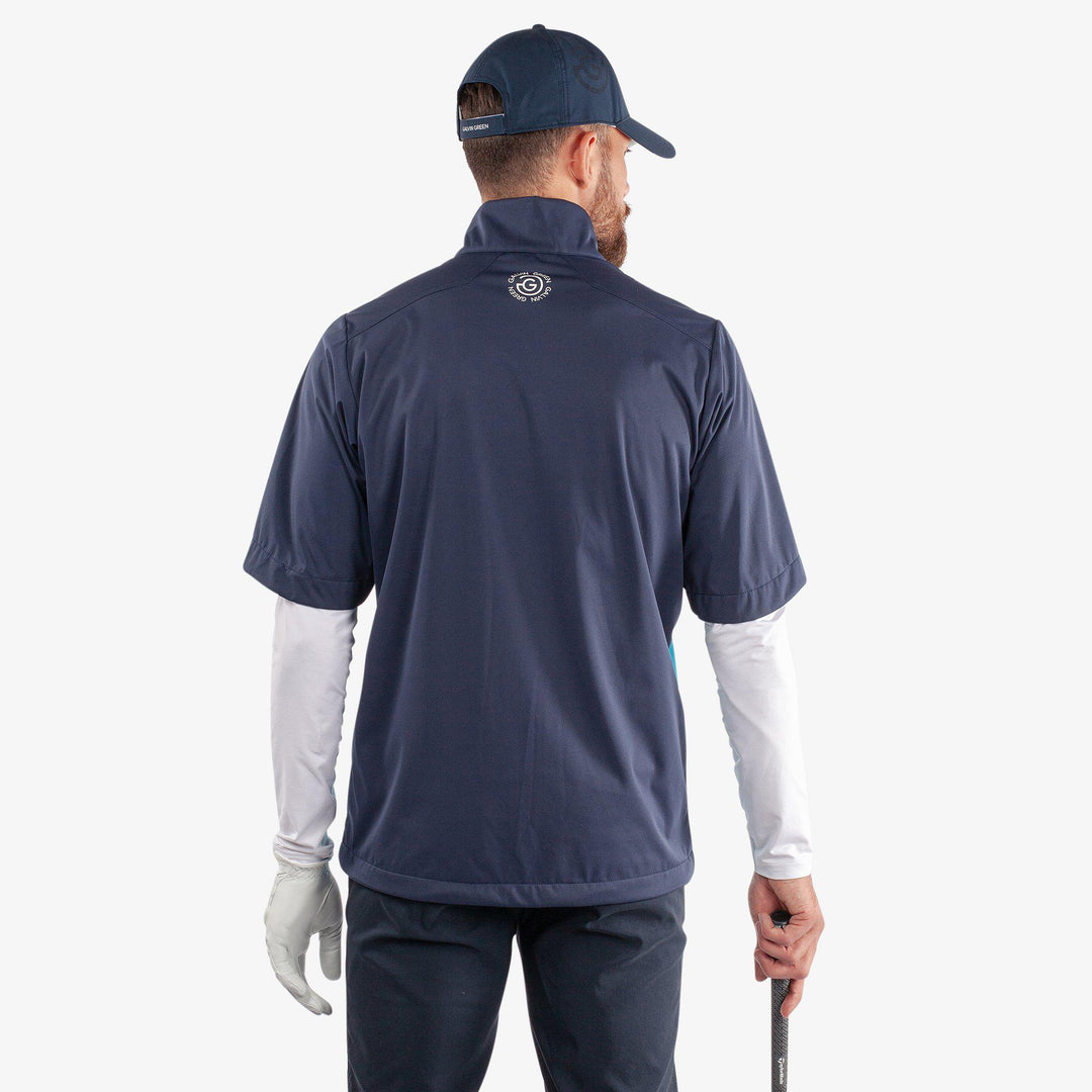 Livingston is a Windproof and water repellent short sleeve golf jacket for  in the color Aqua/Navy(4)