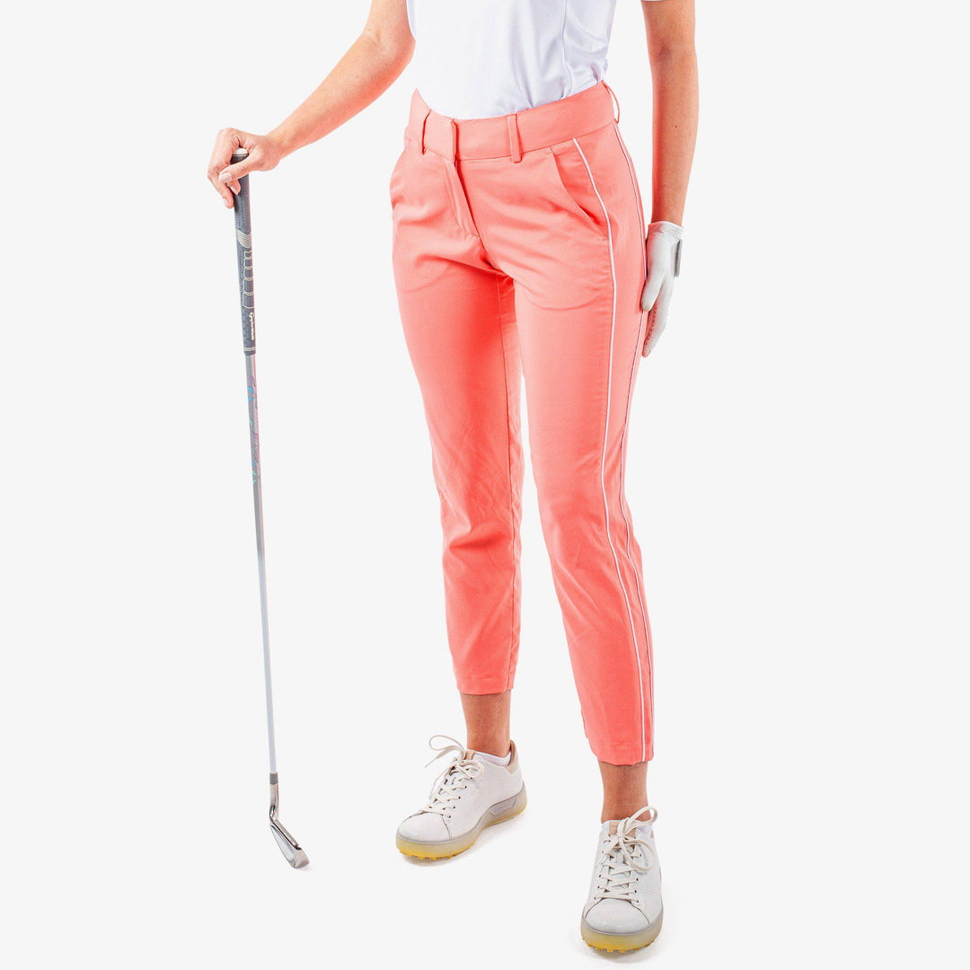 Nicole is a Breathable golf pants for Women in the color Coral/White (1)