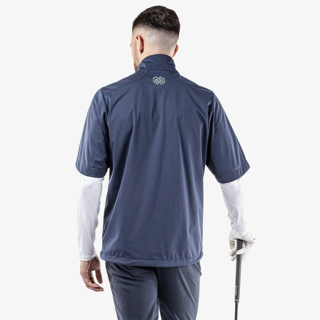 Livingston is a Windproof and water repellent short sleeve golf jacket for  in the color White/Navy/Orange(5)