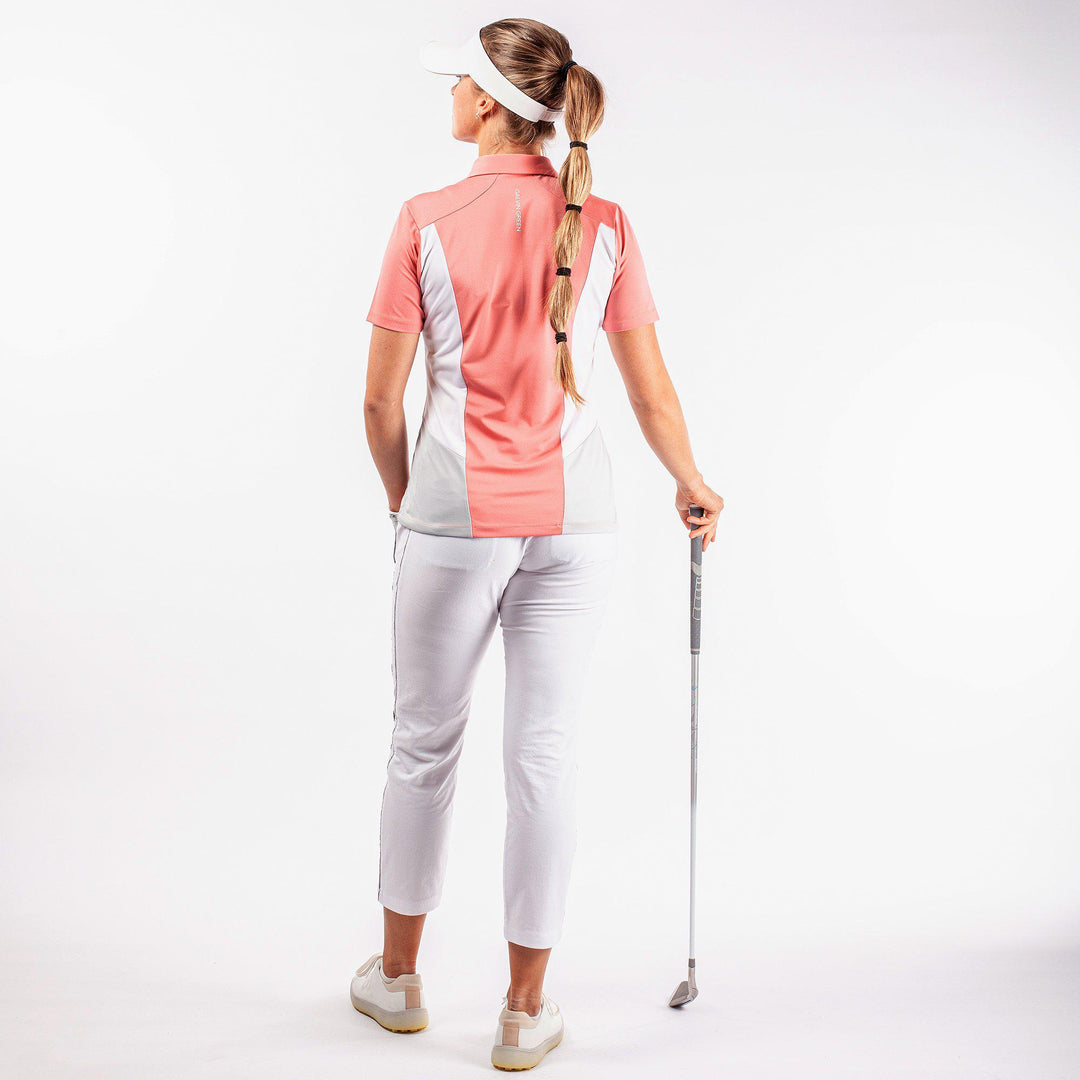 Melanie is a Breathable short sleeve golf shirt for Women in the color Coral/White/Cool Grey(7)