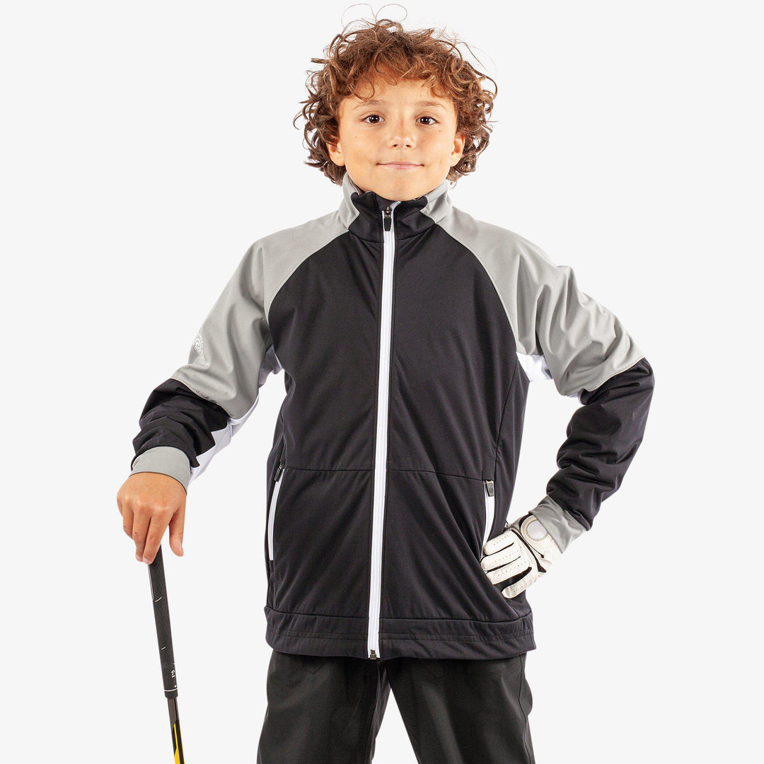 Remi is a Windproof and water repellent golf jacket for Juniors in the color Black/Sharksin/White(1)