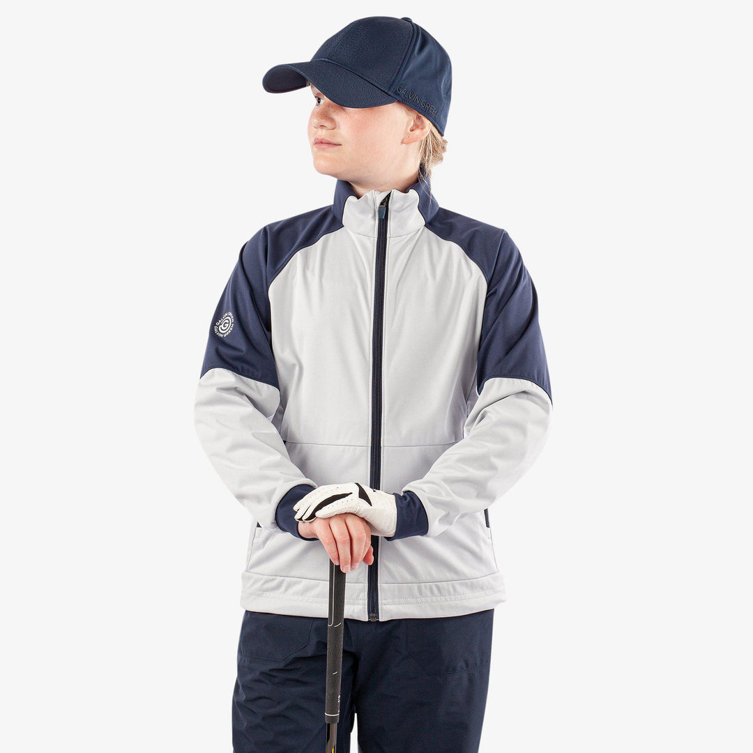 Remi is a Windproof and water repellent golf jacket for Juniors in the color Cool Grey/Navy/White(1)