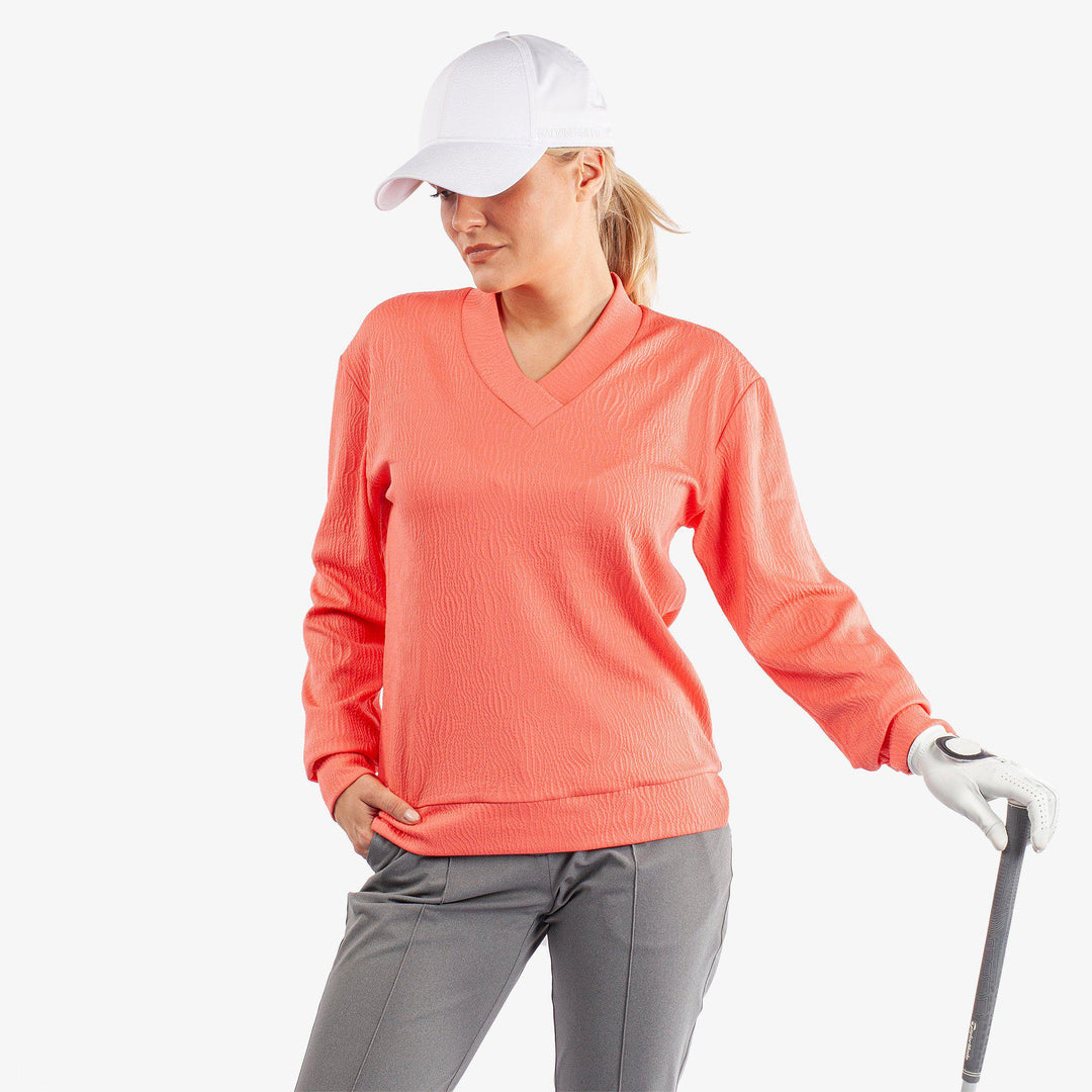 Donya is a Insulating golf mid layer for Women in the color Sugar Coral(1)