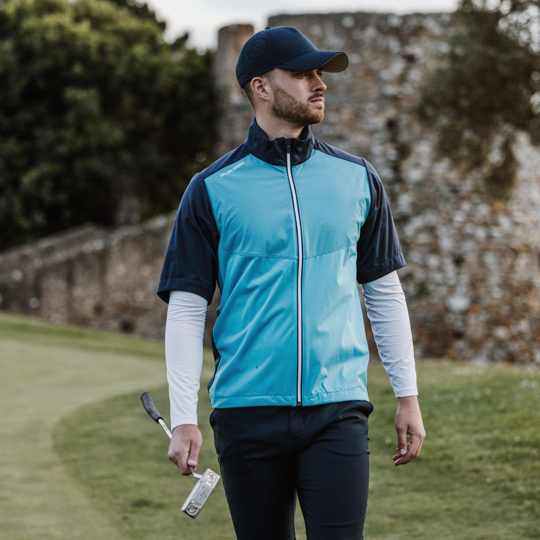 Livingston is a Windproof and water repellent short sleeve golf jacket for  in the color Aqua/Navy(8)