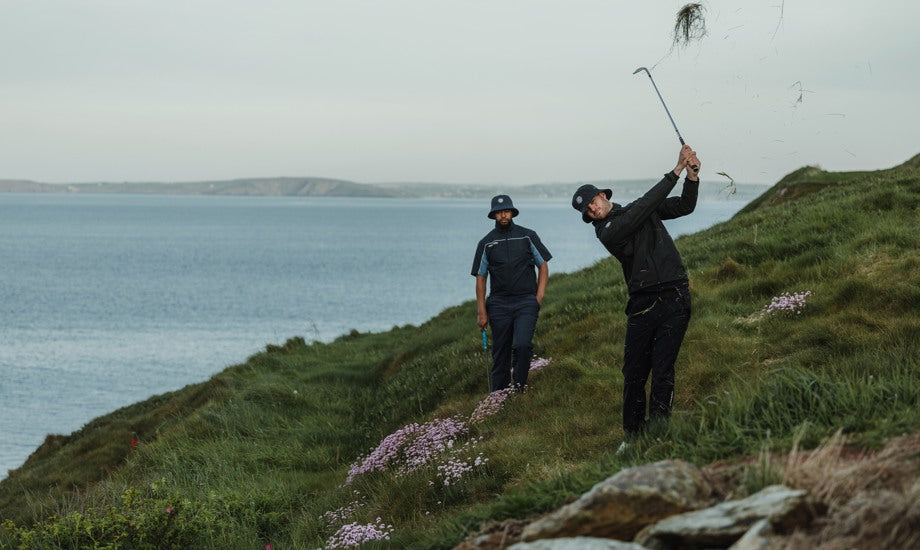 Two male golfers on a golf course, playing golf