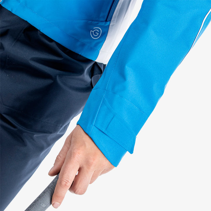 Ally is a Waterproof golf jacket for Women in the color Blue/Cool Grey/White(4)