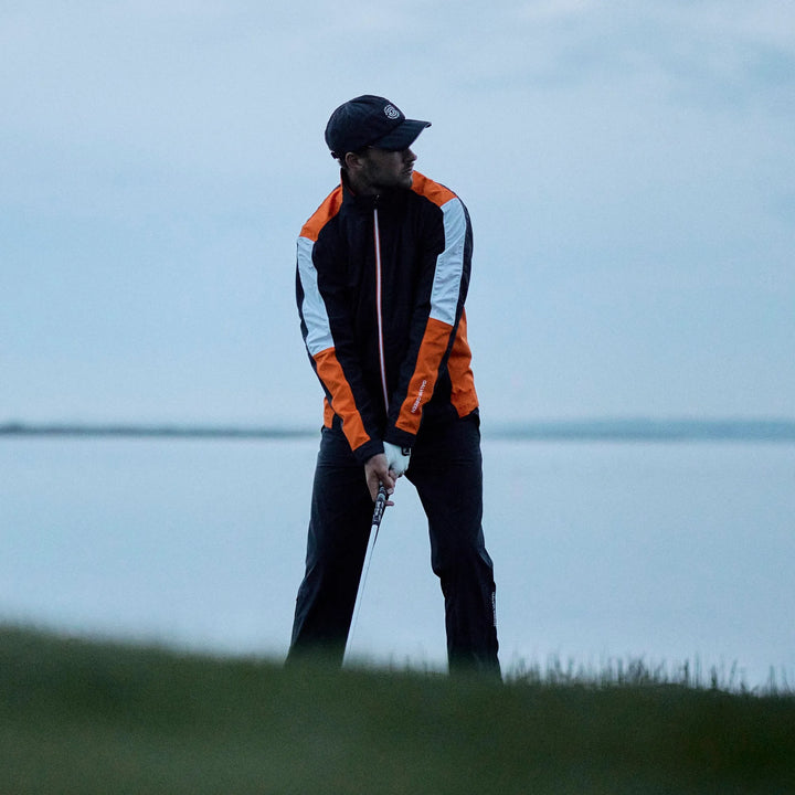 Arlo is a Waterproof Golf Jacket for Men in the color Black/Orange(8)