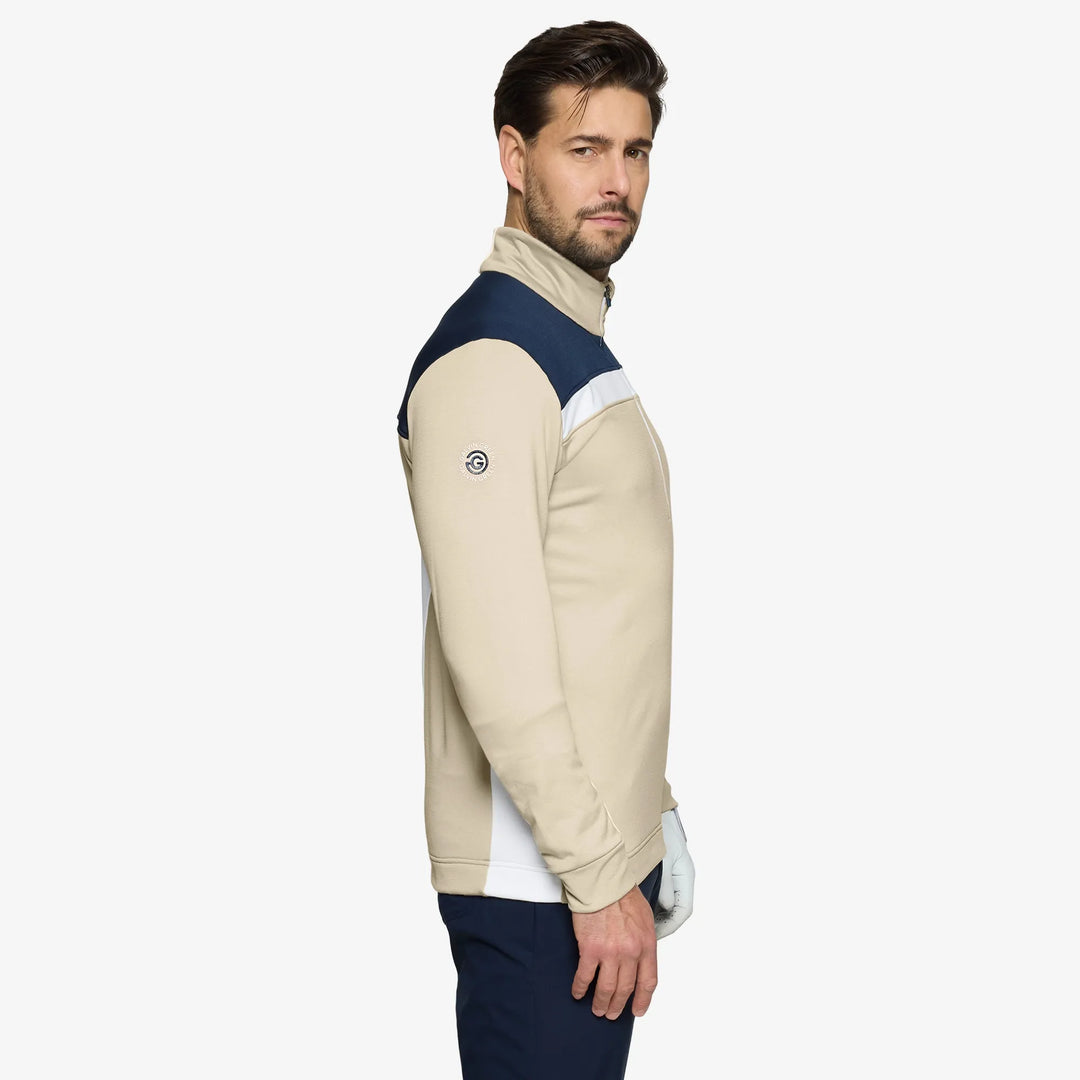 Dean is a Insulating golf mid layer for Men in the color Sand/Navy(3)