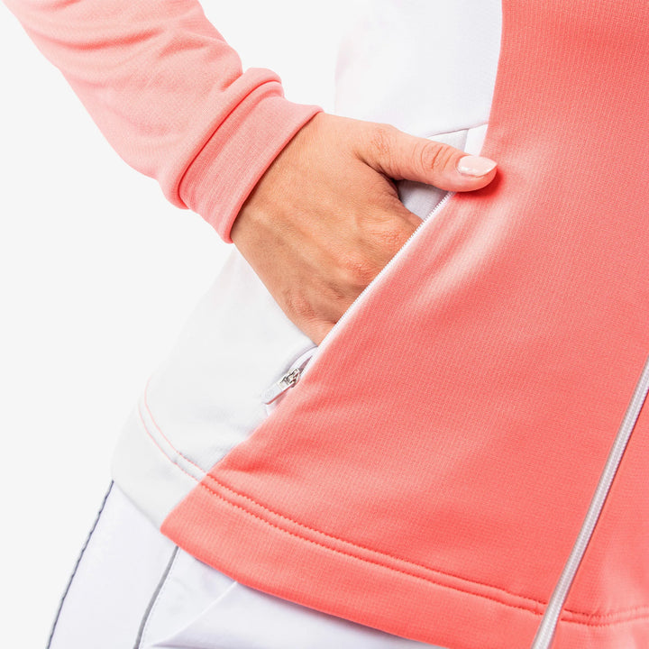 Donella is a Insulating golf mid layer for Women in the color Coral/White/Cool Grey(4)