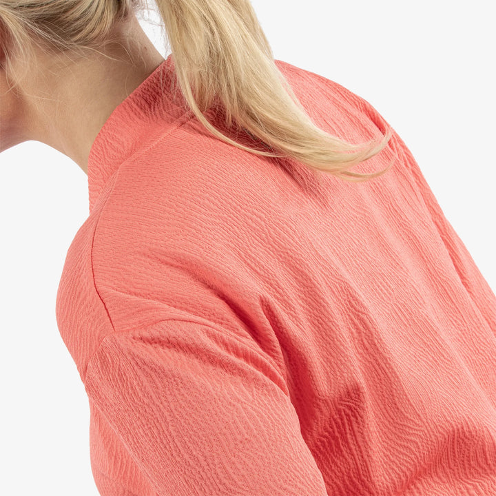 Donya is a Insulating golf mid layer for Women in the color Sugar Coral(7)