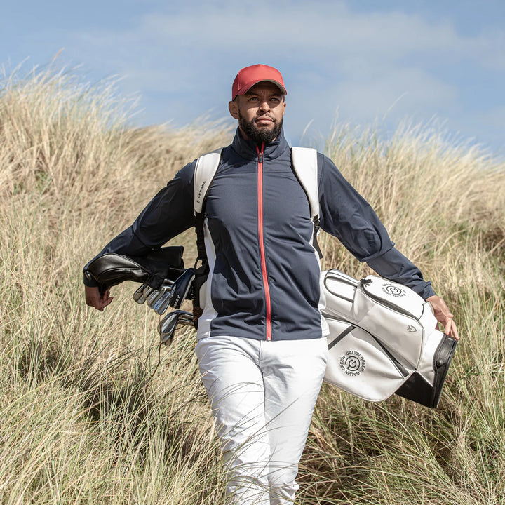 Lloyd is a Windproof and water repellent golf jacket for Men in the color Navy/Red/White(9)