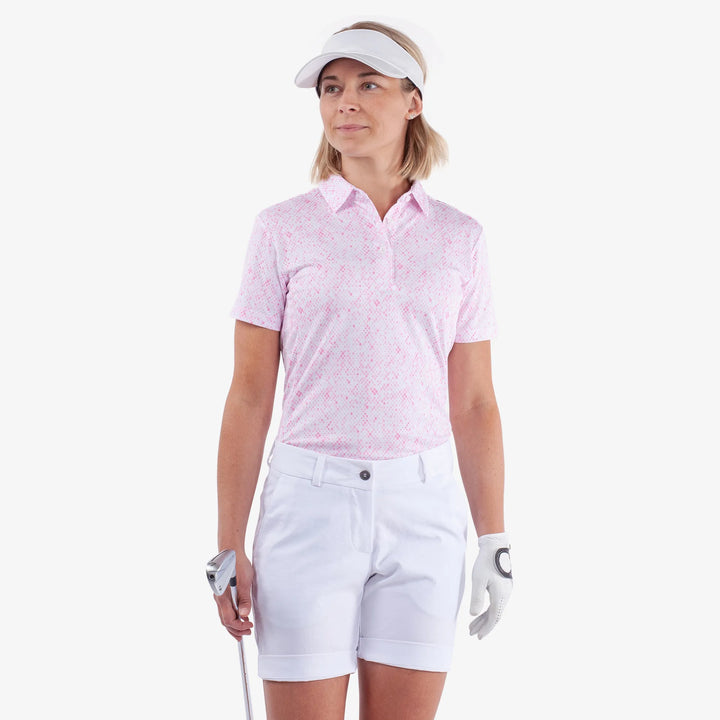 Maud is a Breathable short sleeve golf shirt for Women in the color White/Camelia Rose(1)