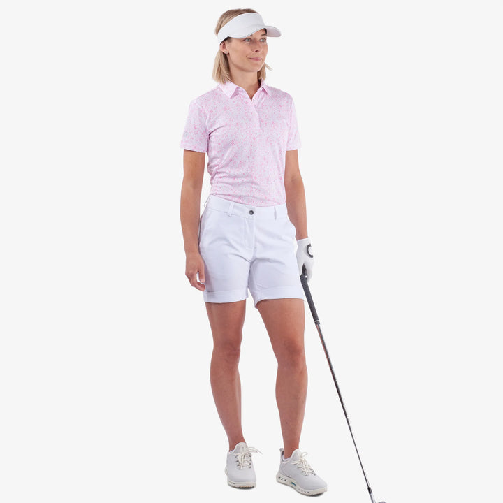 Maud is a Breathable short sleeve golf shirt for Women in the color White/Camelia Rose(2)