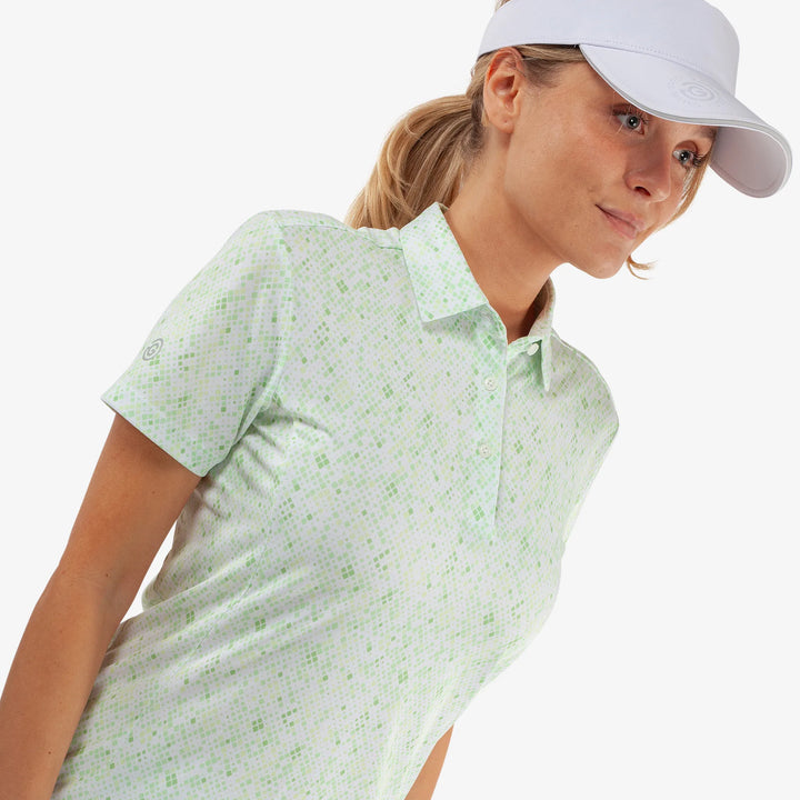 Maud is a Breathable short sleeve golf shirt for Women in the color White/Fresh Green(3)