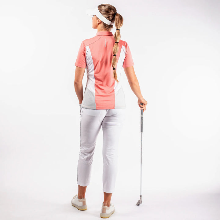 Melanie is a Breathable short sleeve golf shirt for Women in the color Coral/White/Cool Grey(7)