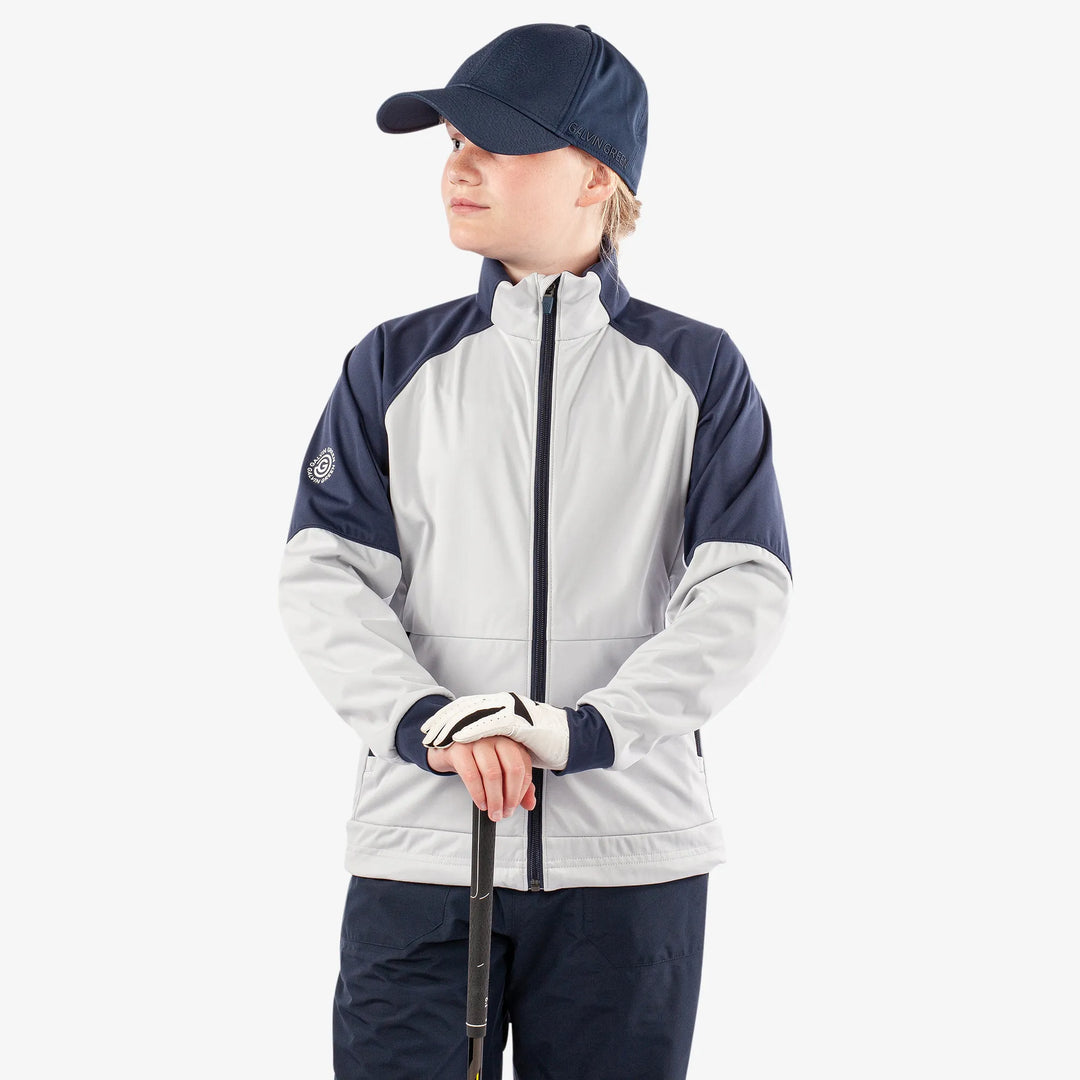 Remi is a Windproof and water repellent golf jacket for Juniors in the color Cool Grey/Navy/White(1)