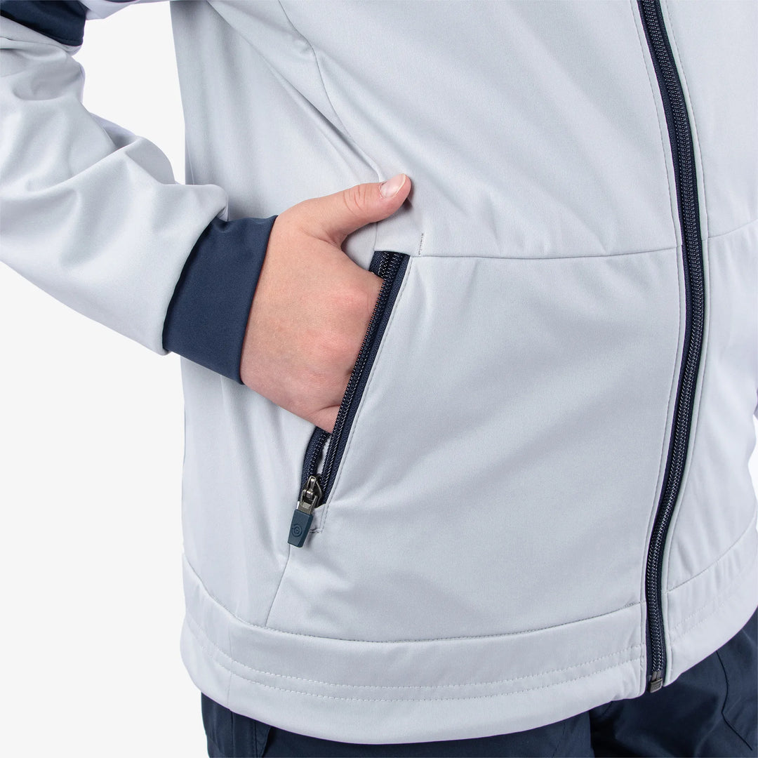 Remi is a Windproof and water repellent golf jacket for Juniors in the color Cool Grey/Navy/White(5)