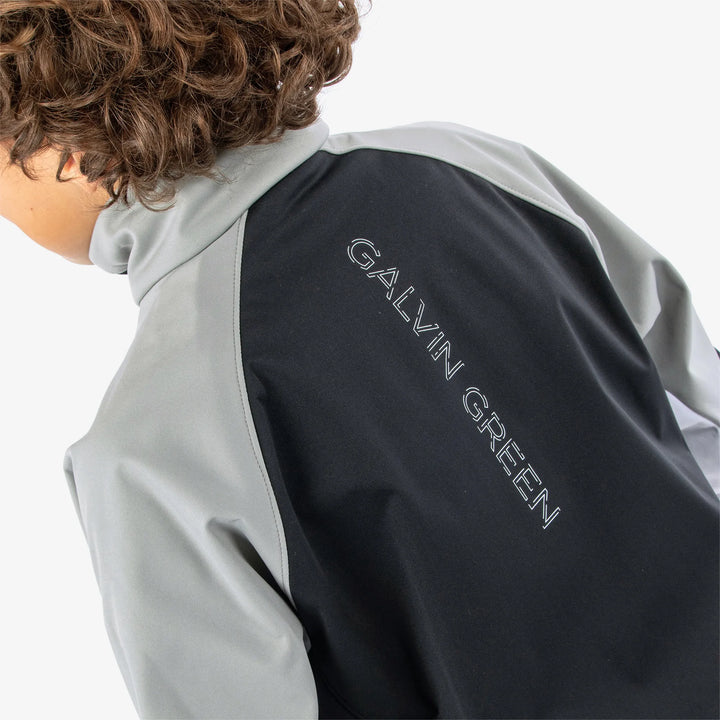 Remi is a Windproof and water repellent golf jacket for Juniors in the color Black/Sharksin/White(8)