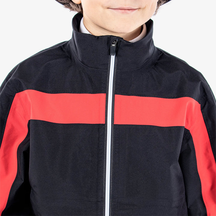 Robert is a Waterproof golf jacket for Juniors in the color Black/Red(3)