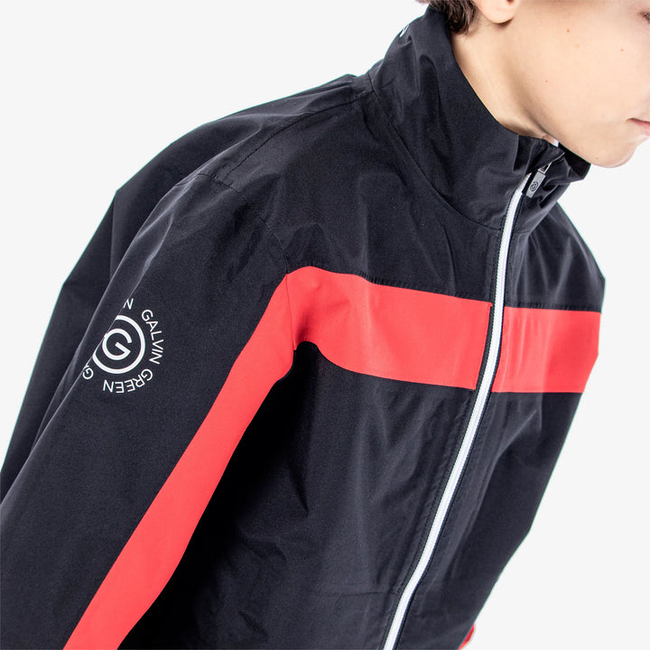 Robert is a Waterproof golf jacket for Juniors in the color Black/Red(4)