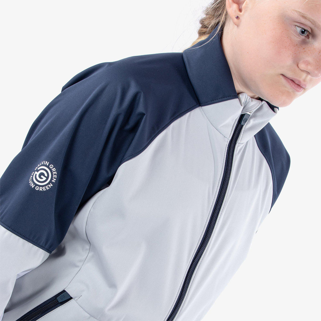 Remi is a Windproof and water repellent golf jacket for Juniors in the color Cool Grey/Navy/White(4)