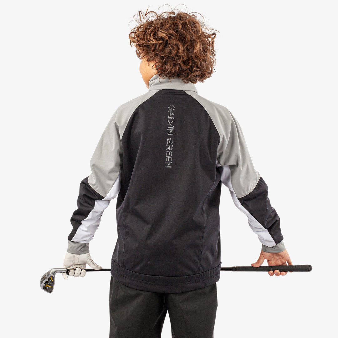 Remi is a Windproof and water repellent golf jacket for Juniors in the color Black/Sharksin/White(7)