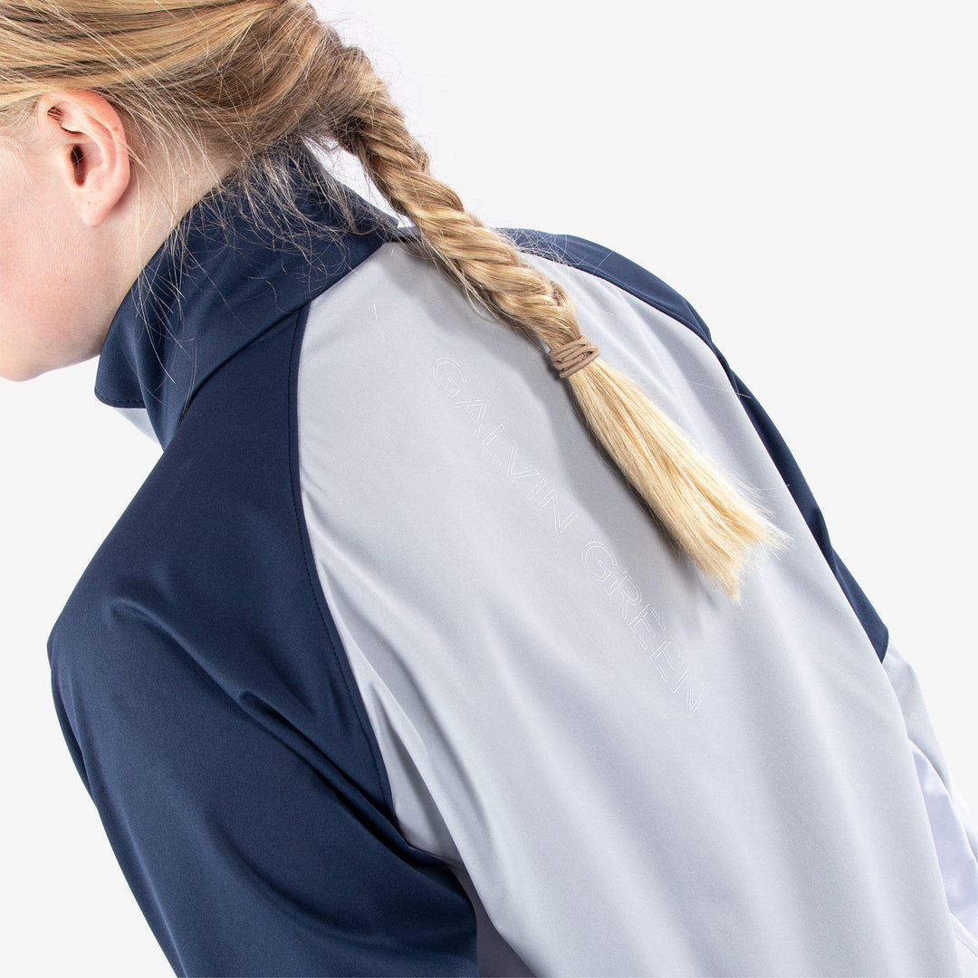 Remi is a Windproof and water repellent golf jacket for Juniors in the color Cool Grey/Navy/White(7)