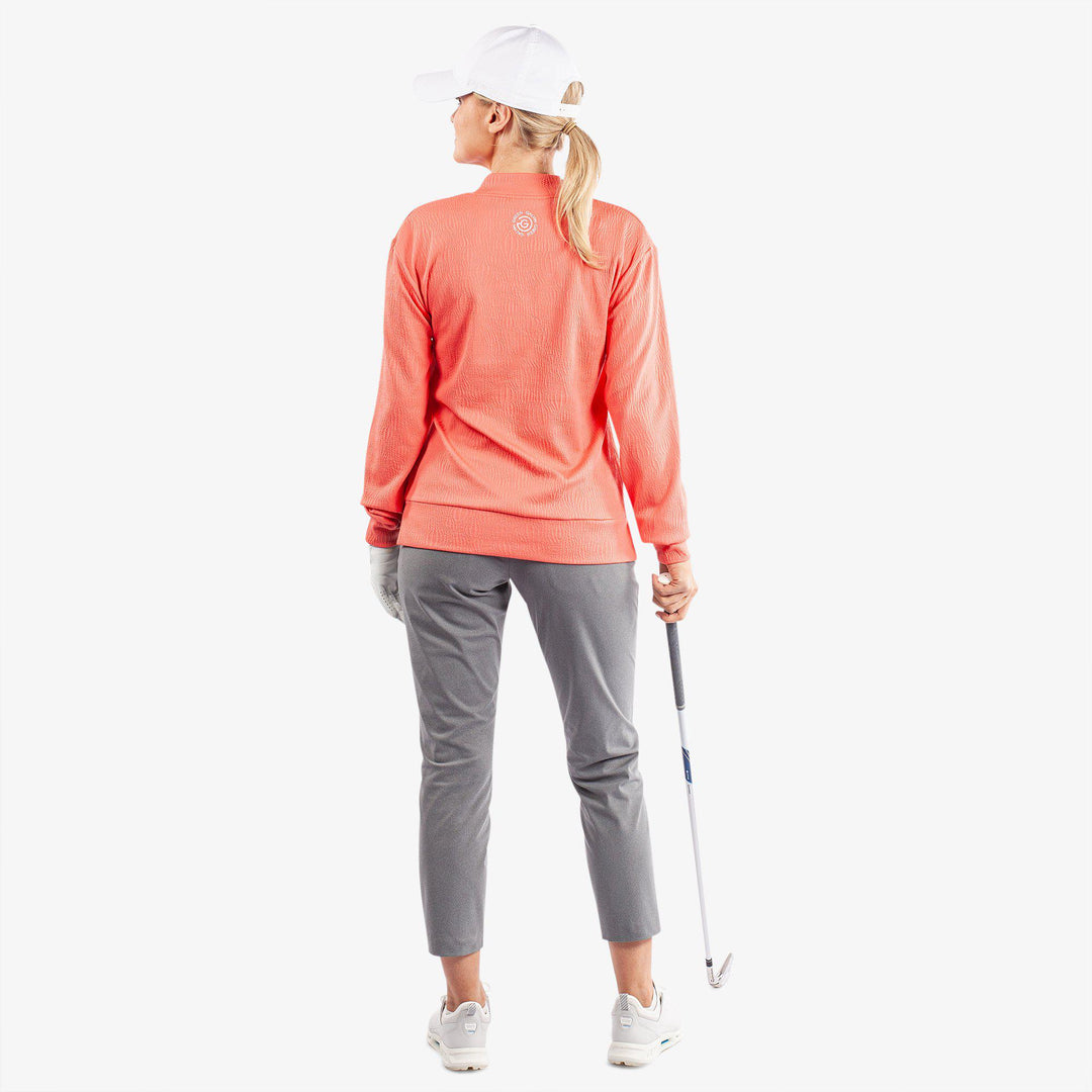 Donya is a Insulating golf mid layer for Women in the color Sugar Coral(8)
